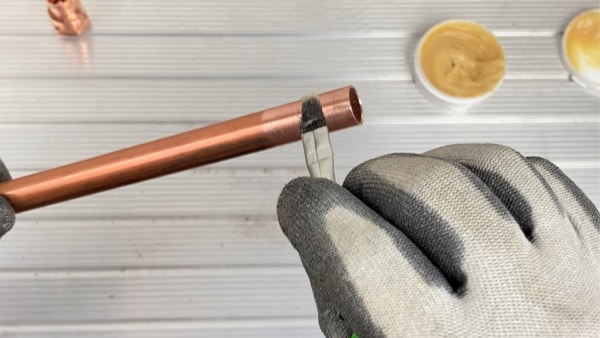 Apply flux to copper pipe